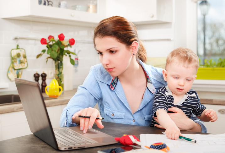 Young mother working with her baby from home